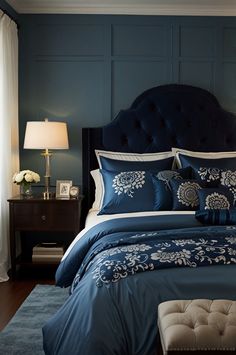 a bed with blue comforter and pillows in a bedroom