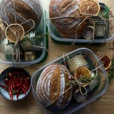 three plastic containers filled with food on top of a wooden table and covered in twine