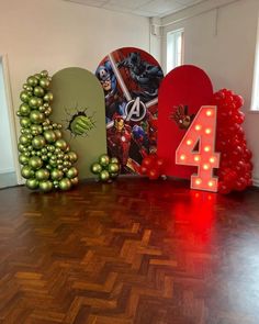 the number four is displayed in front of balloons and christmas decorations, along with an iron man tree