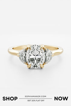 a three stone engagement ring with the words shop now