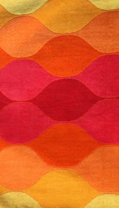 an orange, pink and yellow rug with wavy lines on the bottom in different colors