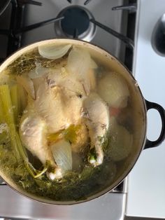 a pot filled with food sitting on top of a stove