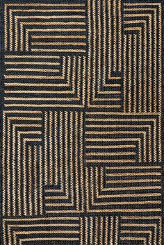 a black and brown rug with squares on it