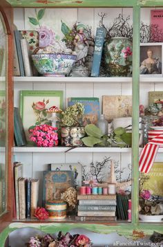 a book shelf filled with lots of books and vases on top of each other