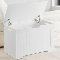 a white storage box sitting on top of a bed