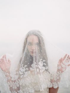 a woman wearing a veil with her hands in the air