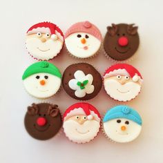 cupcakes with frosting decorated as santa claus and snowmen are arranged in a circle