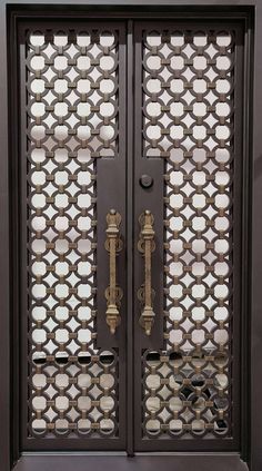 an ornate iron door with decorative designs on the front and side panels, in dark wood