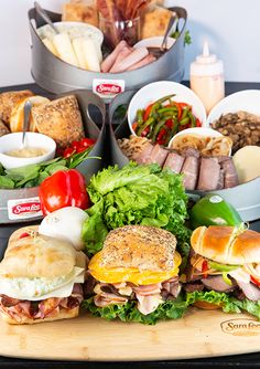 several sandwiches are arranged on a cutting board