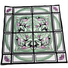 a square stained glass window with flowers and leaves on it's sides, showing the design