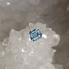 a blue diamond sitting on top of ice