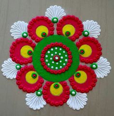 a red and green flower with white petals