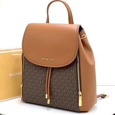 Brand New With Tag Michael Kors Medium Phoebe Flap Drawstring Backpack Pvc Leather Color: Vanilla Gold Toned Hardware Mk Brown Signature Color Michael Kors Logo On Front 2 Side Zip Pocket At Front Flap Snap Top Closure Custom Fabric Lining 2 Slip In Pocket 1 Zipper Pocket 11.75" (L) 13"(H) 5.25"(D) 3.25" Top Handle, Adjustable Backpack Straps Michael Kors Backpack With Detachable Strap, Leather Backpack With Branded Hardware For Travel, Luxury Michael Kors Backpack With Detachable Strap, Luxury Backpack For Errands, Designer Leather Backpack For Errands, Michael Kors Rhea Backpack, Michael Kors Mini Backpack, Mini Leather Backpack, Studded Backpack