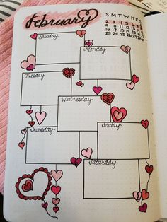 an open planner with hearts on it and the word february written in cursive writing