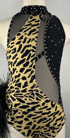 the back of a woman's leotard top with black and gold animal print