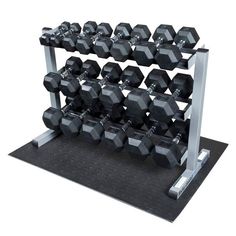 a pair of dumbbells sit on a metal rack in front of a white background