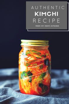 a glass jar filled with food sitting on top of a blue cloth next to a black background