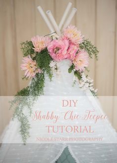 a wedding cake with pink flowers and greenery on top