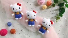 three crocheted hello kitty dolls sitting next to each other