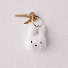 a stuffed animal keychain hanging on a wall