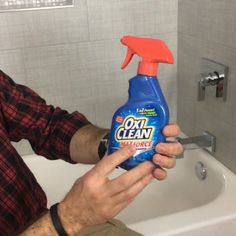 a man is holding a bottle of toilet cleaner