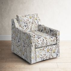 a white chair sitting on top of a hard wood floor next to a plant covered wall