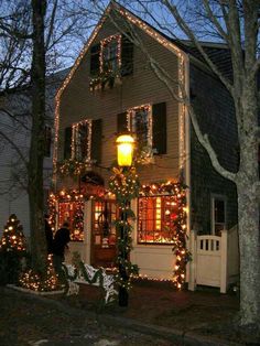 a house decorated with christmas lights and garlands