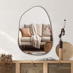 a living room filled with furniture and a large mirror