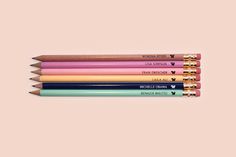 six pencils with different colored writing on them