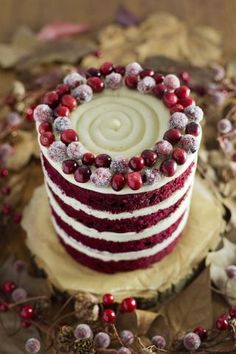 a red velvet cake with white frosting and cranberries