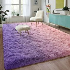 a living room with a purple rug and white chair in it's center area