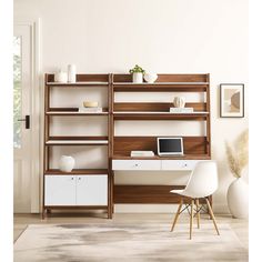 a room with a desk, chair and computer on the shelf next to an open door