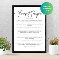 a framed print with the words, happy pray on it next to potted plants