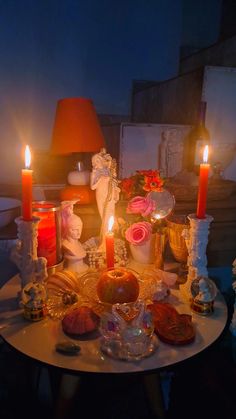 a table topped with lots of candles and dishes