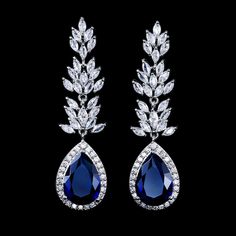 Sapphire Blue Bridal and Formal Earrings Add a glamorous touch to your special day with these glistening earrings. These stunning crystal drop chandelier earrings feature a unique and stylish design embellished with a dazzling mix of clear and sapphire blue crystals on a silver finish. Size: about 2 1/2" long. Color: Silver/Clear/Sapphire Blue. Style: E1949. Need several pair of earrings for your bridal party? You can buy in bulk and save! Model is also wearing our Blush Pink Marabou Feather Bri Formal Earrings, Prom Accessories, Anime Jewelry, Prom Earrings, Winter Weddings, Wedding Accessories Jewelry, Missing Link, Gold Earrings Designs