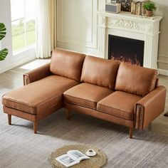 a living room with a couch and a fire place in the corner, next to a fireplace