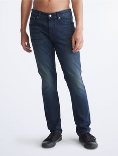 An iconic essential, our reimagined jeans are made with flexible stretch denim for enhanced movement and all-day comfort. Updated with signature metal logo hardware, a Calvin Klein hallmark. Cut in a slim fit with considered detailing and reinforced seams.  Material: Forever Black Wash. Leg Care, Flexible Stretches, Metal Logo, Slim Leg, Slim Jeans, Metallic Logo, Slim Legs, Slim Fit Jeans, Stretch Denim