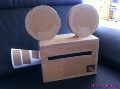 a wooden box with two speakers on it sitting on a table next to a couch