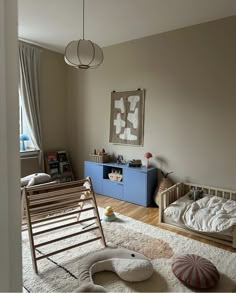 a child's bedroom with a rocking chair, bed and toys on the floor