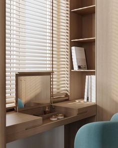 a desk and chair in a room with wooden slats on the window sill