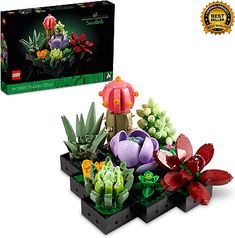 a lego planter with flowers and plants in it next to a box that says