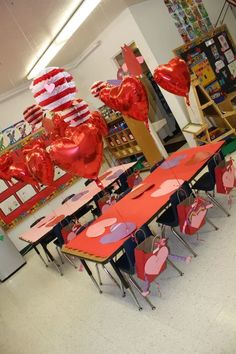 the room is decorated for valentine's day with heart balloons