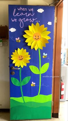 a door decorated with flowers and bees for the school's new classroom year celebration