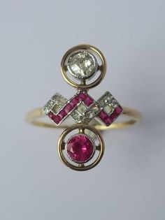 Rare antique Toi et Moi ring in solid 18-carat (750 thousandths) yellow gold and platinum, owl hallmark and mascaron hallmark affixed by the Warranty Office. French Art Deco work from the 1940s. Important ring head with geometric cross decoration, adorned with a round old-cut diamond and a synthetic Verneuil ruby of a very bright red color, measuring 4 mm in diameter, bezel-set in a pearl-cut platinum surround itself nested in a contrasting yellow gold circle. In the center, eleven small rose-cut diamonds, plus eleven calibrated square synthetic rubies, set in platinum. This ring has two twin parts facing each other. It is a jewel symbolic of fidelity, which was traditionally offered for engagements, wedding anniversaries or for births. Estimated weight of diamonds: 0.25 carat for the main Ring With Ruby, Deco Originale, Gold Circle, Small Rose, French Art Deco, Ruby Diamond, Multi Stone Ring, French Art, Multi Stone