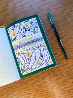 an open notebook sitting on top of a wooden table