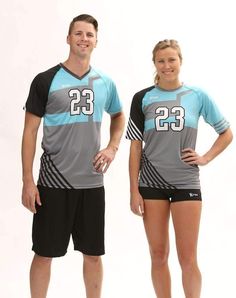 a man and woman standing next to each other wearing matching shirts with numbers on them