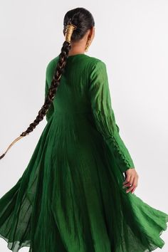 Green slub silk anarkali with beaded hand embroidered yoke and centre panel. Comes with a tissue inner.
Components: 2
Pattern: Hand embroidered
Type Of Work: Beads
Neckline: Anarkali : V Neck, Inner : Round
Sleeve Type: Anarkali : Puffed Sleeves, Inner : Sleeveless
Fabric: Anarkali : Slub silk, Inner : Tissue
Color: Green
Other Details: 
Closure : Anarkali - Potli buttons
Occasion: Puja - Aza Fashions Bohemian Wedding Kurta With Dori Work, Green Anarkali, Silk Anarkali, Beaded Neckline, Womens Tunics, Anarkali, Aza Fashion, Puff Sleeve, Hand Embroidered