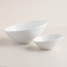 two white bowls sitting next to each other