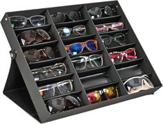 PRICES MAY VARY. SUNGLASSES DISPLAY STAND: This classy black sunglass case makes a statement while helping you store your favorite eyeglasses in a secure place. This organizer holds 18 pairs of glasses in the available slots, and the cover of the case opens easily with a snap. The stand dimensions are 18.5 " L x 14.6" W x 2.4 " H. SAFE STORAGE COMPARTMENT: The design of this case creates a great holder for your collection of fragile sunglasses and eyeglasses. Don't rely on a single, that only fits one pair at a time. Instead of leaving expensive eyewear to the mercy of thin foam or fabric sleeves, organize a large number of glasses or other delicate pieces out of sight until they are needed. MAKEUP & ACCESSORIES ORGANIZER: Don't have 18 different pairs of glasses? Use this display tray to Glasses Organization, Travel Display, Glasses Organizer, Glasses Display, Eyewear Display, Glasses Storage, Ballerina Jewelry, Sunglasses Display, Sunglasses Storage