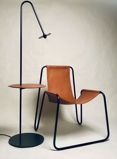 an orange chair sitting next to a black table